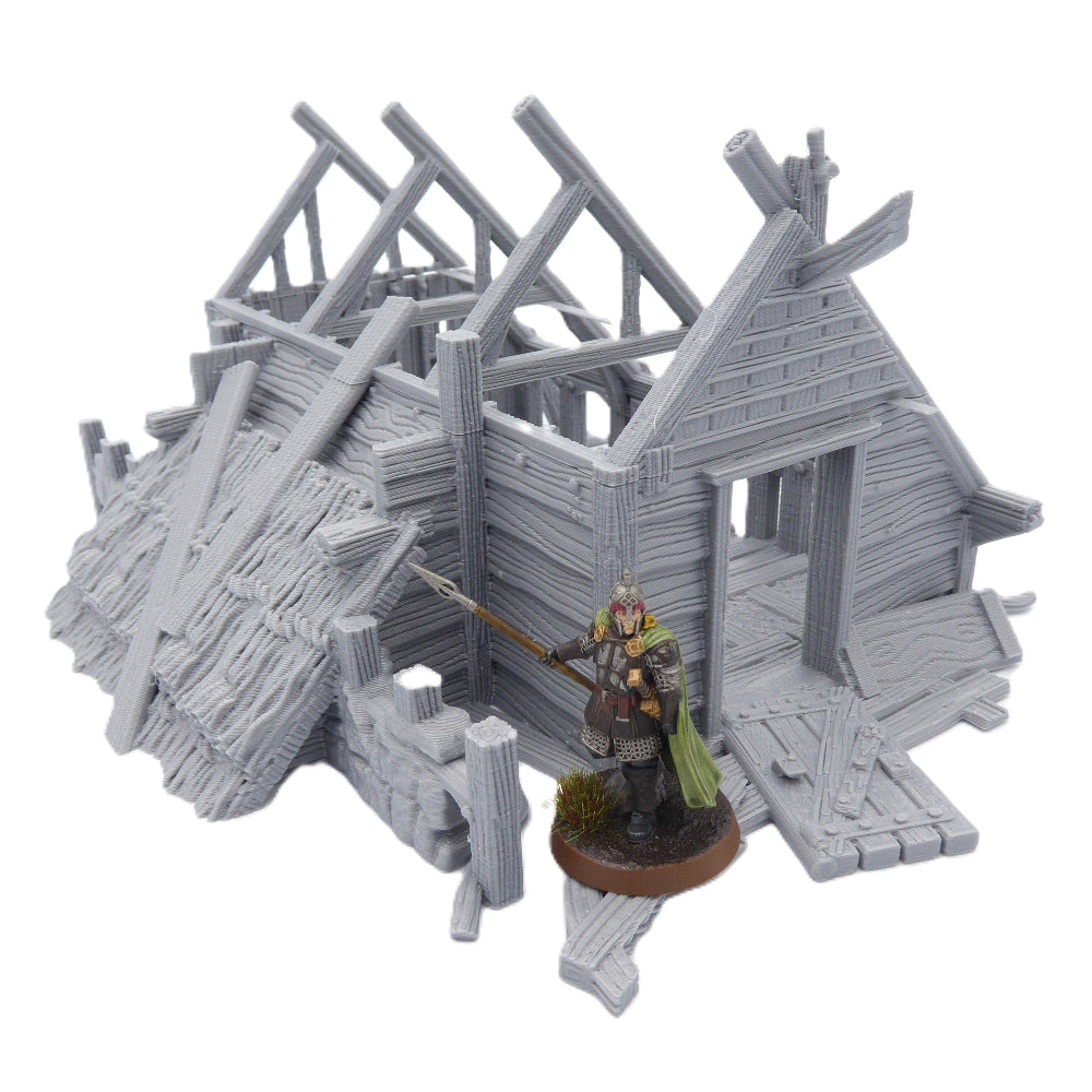 Miniature figure of a warrior standing in front of a gray wooden structure on a white background