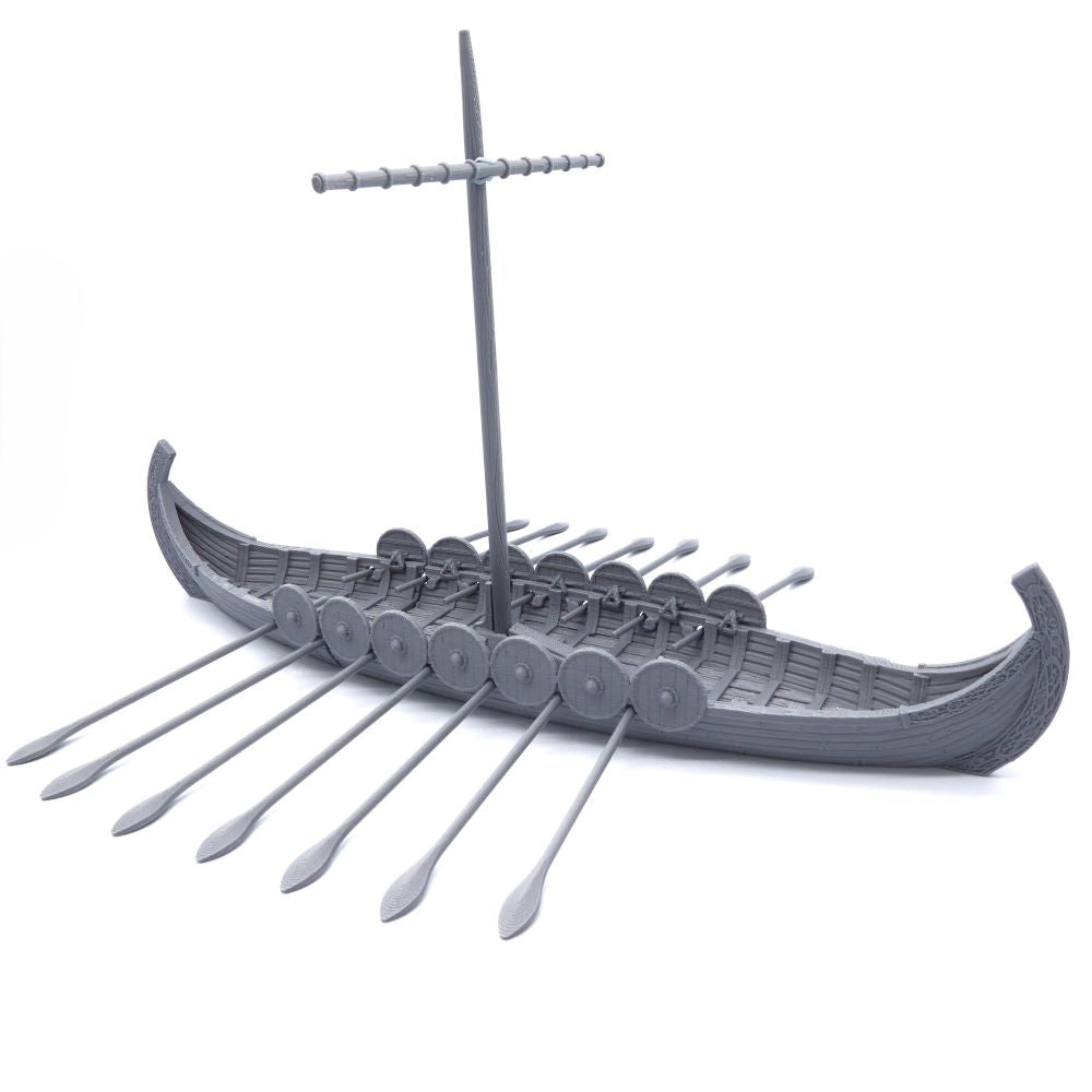Model of a Viking longship with oars on a white background