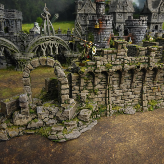 Model of a stone castle with detailed architecture and a figure on a horse.