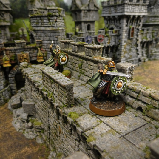 Miniature figures of warriors on a stone wall with a castle-like background