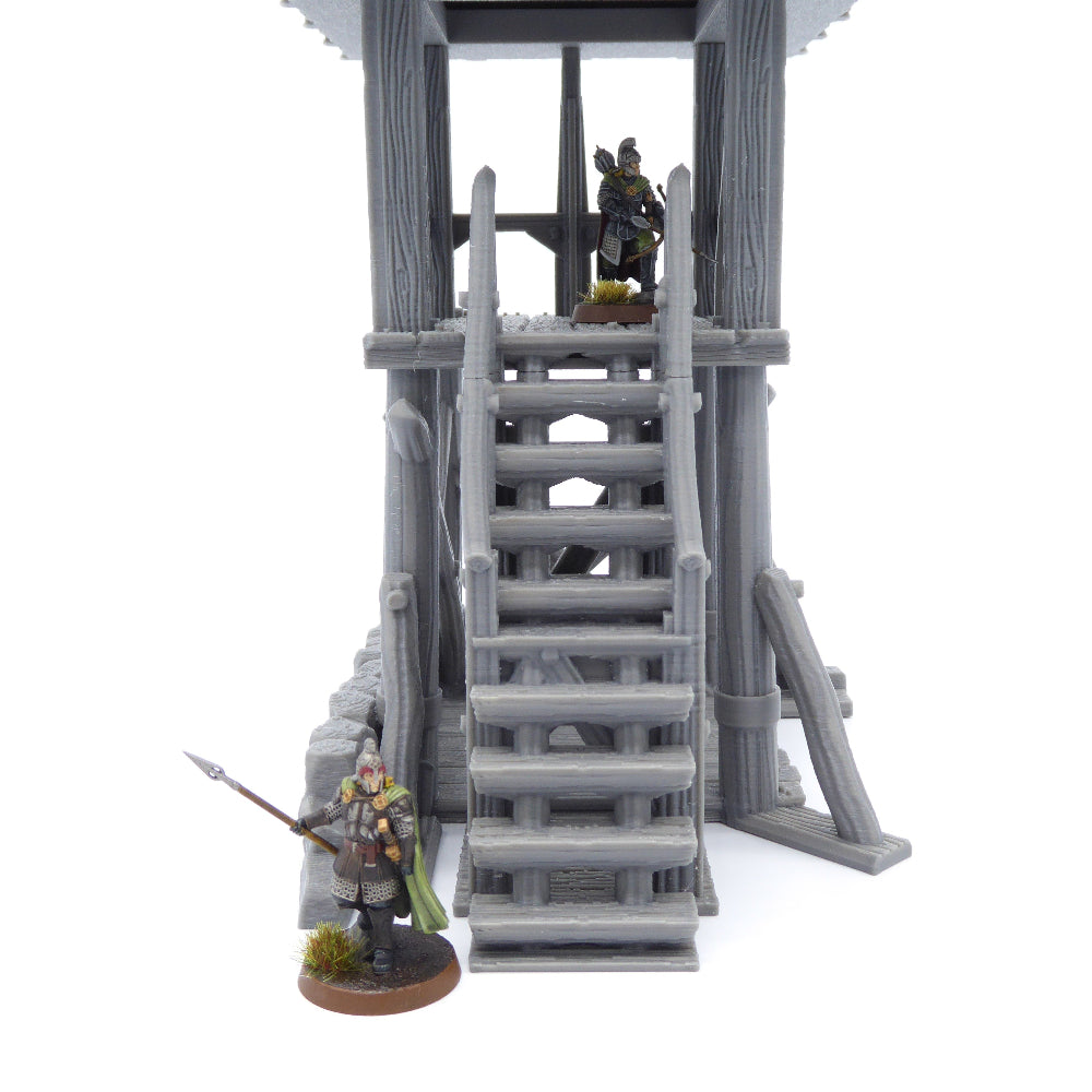 Model of a watchtower with two figures on a white background